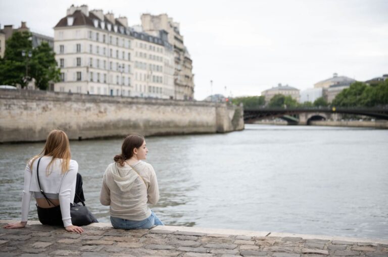 paris-academia-students-sitting-by-seine-river