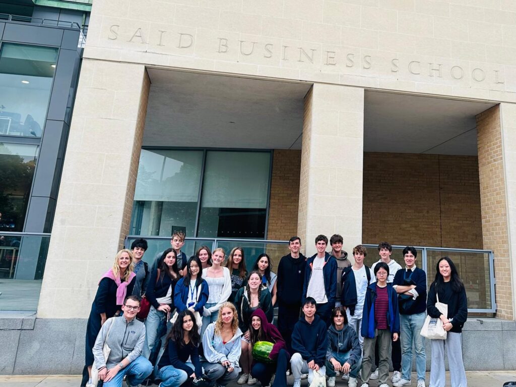 students in front of said business school