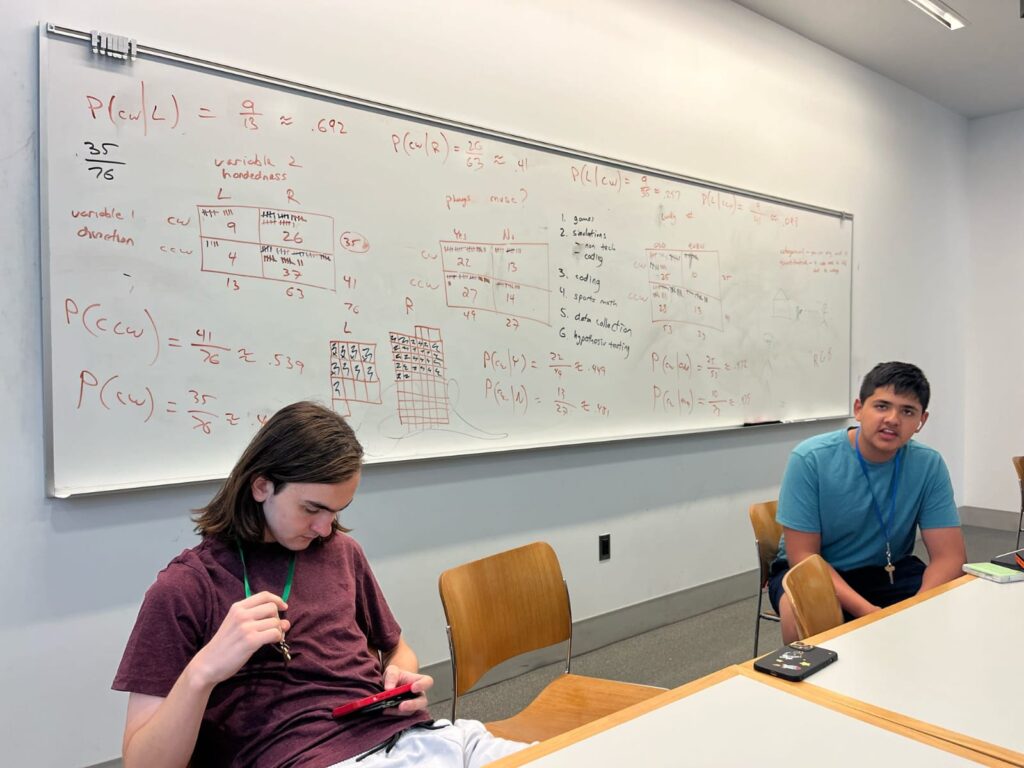 two students sitting at desks