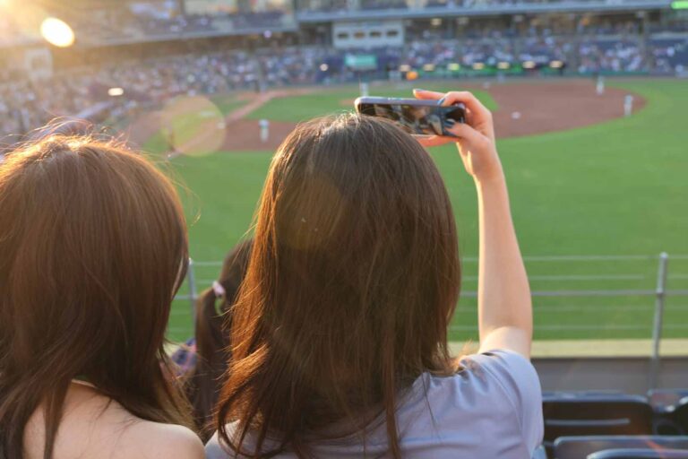 Two student take picture of baseball field