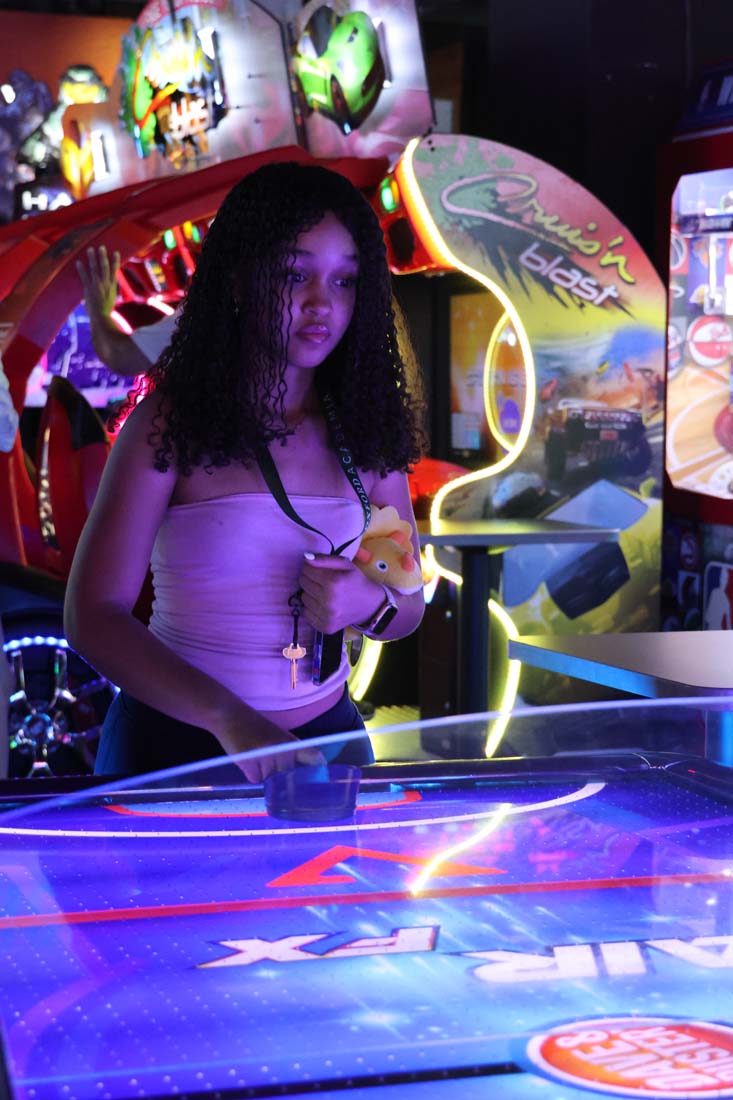 Student plays colorful arcade game