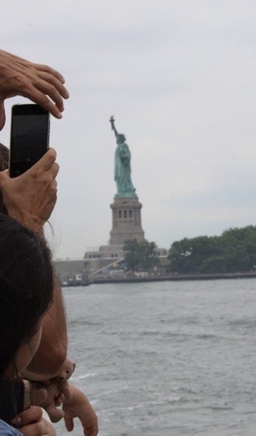 Student takes photo of statues of liberty