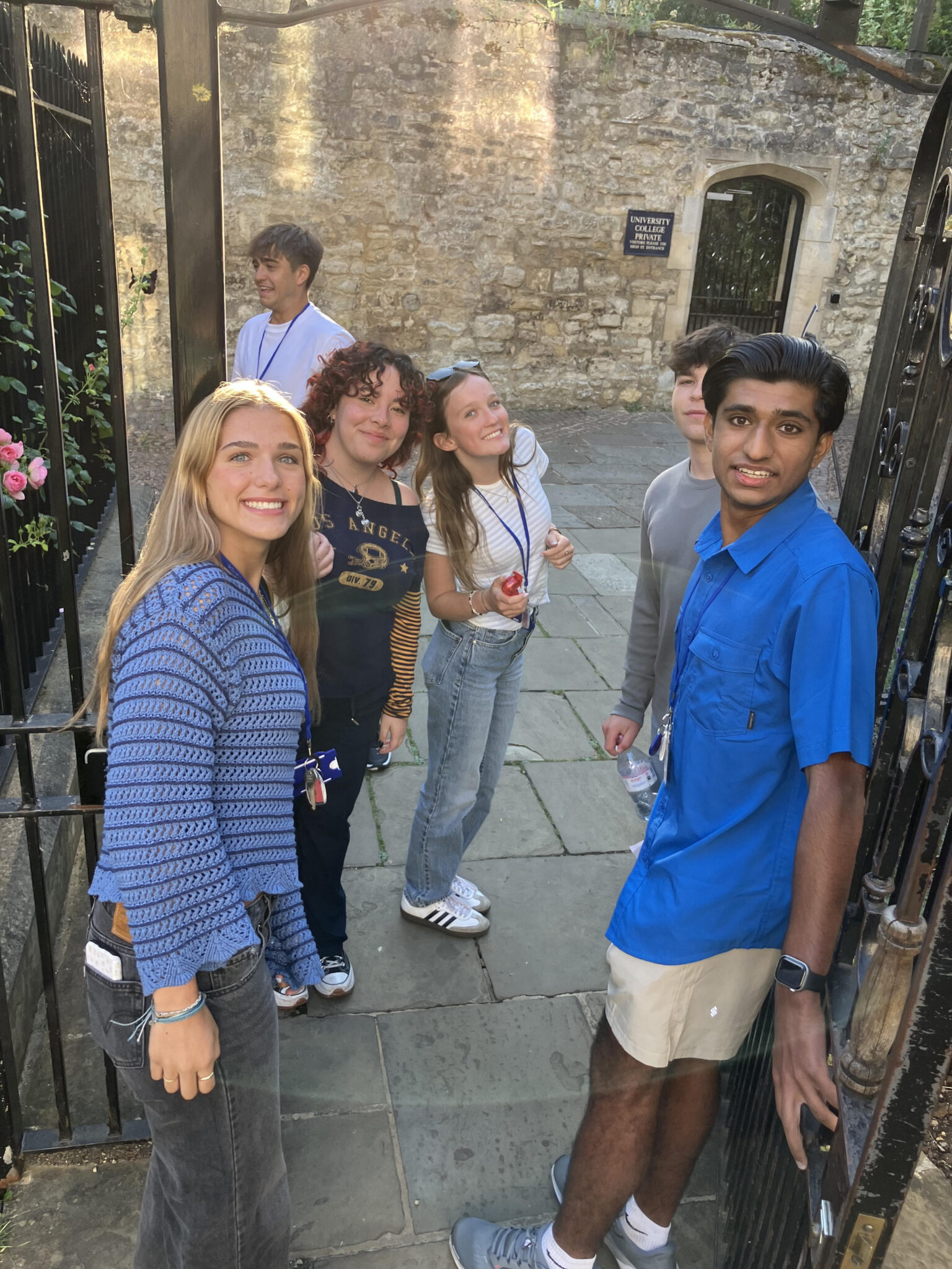 A group of student stands at the botanical gardens in Oxford.