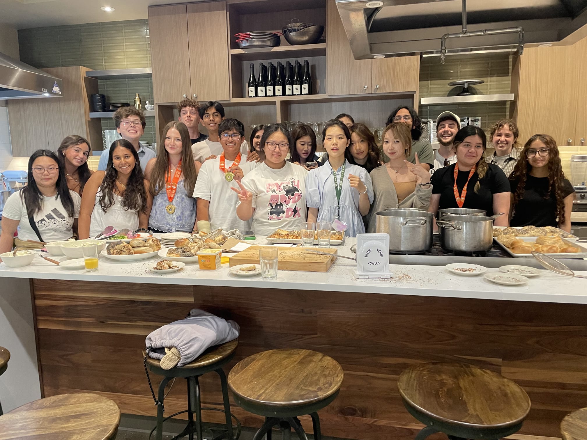 Student pose for group photo in kitchen with instructor