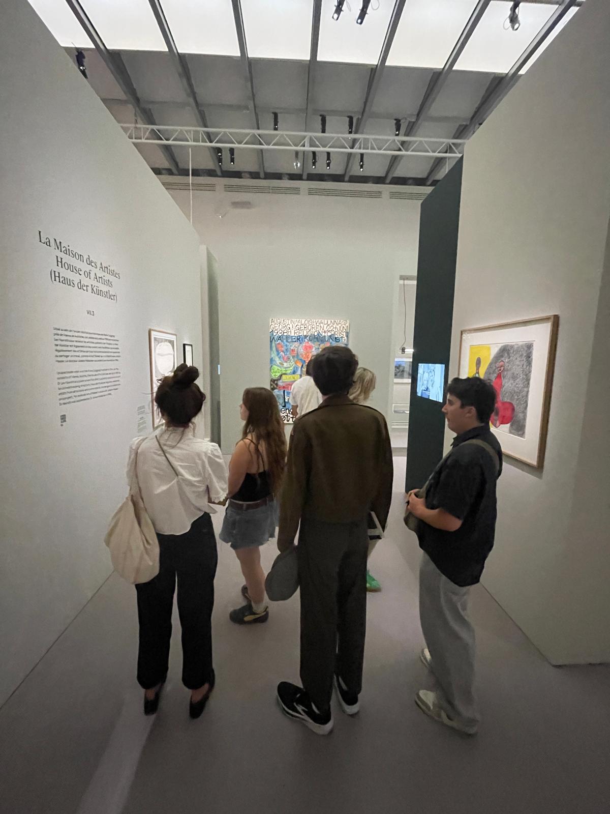 Two students and an instructor walk through display at the Grand Palais