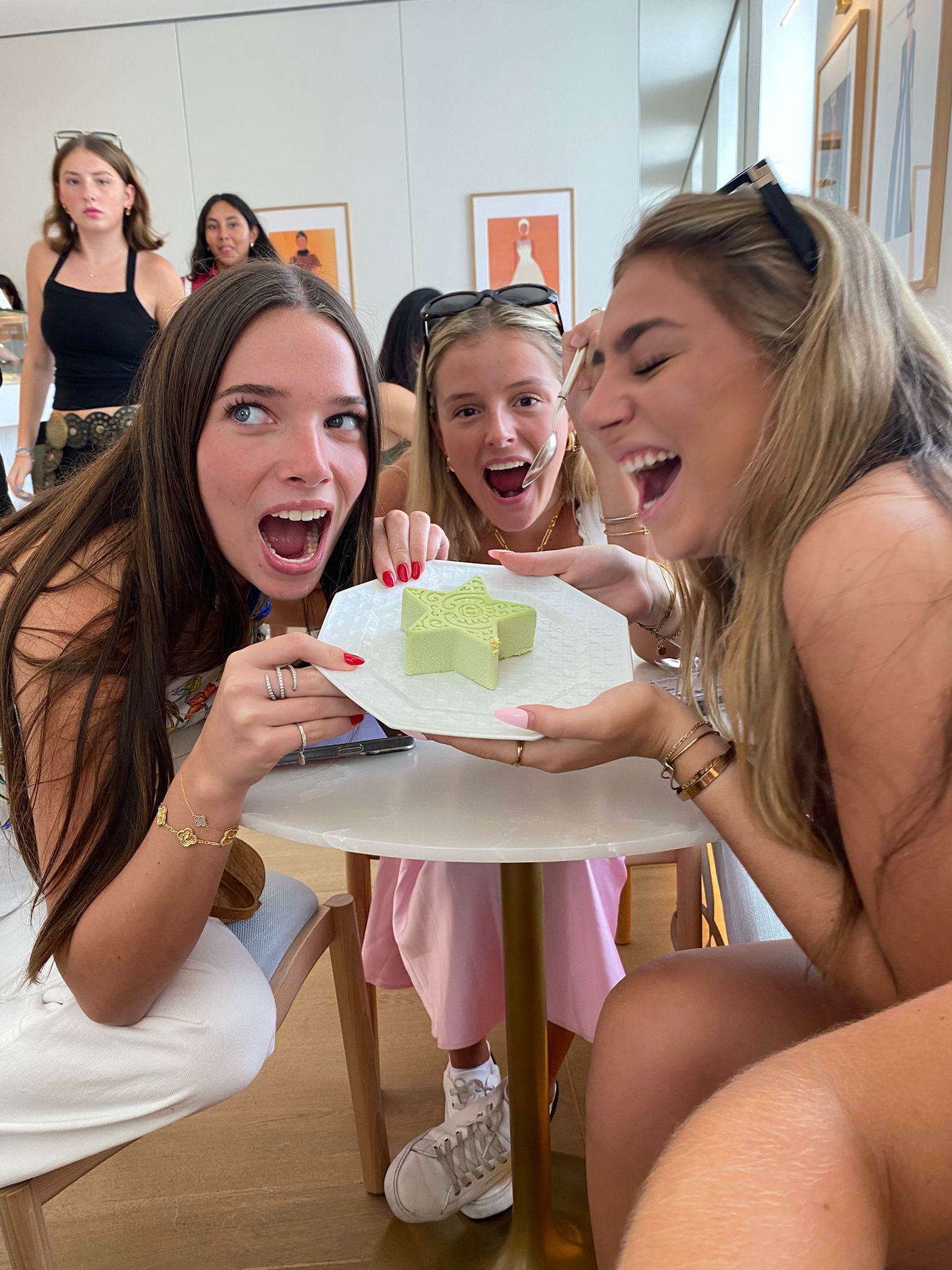 Three students excitedly hold up star shaped dessert