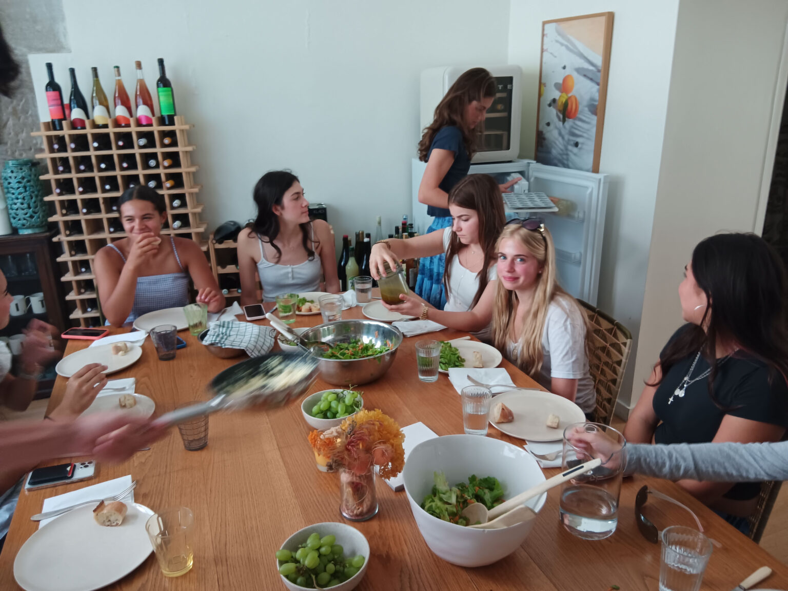 Student sit at table eating a fresh meal together