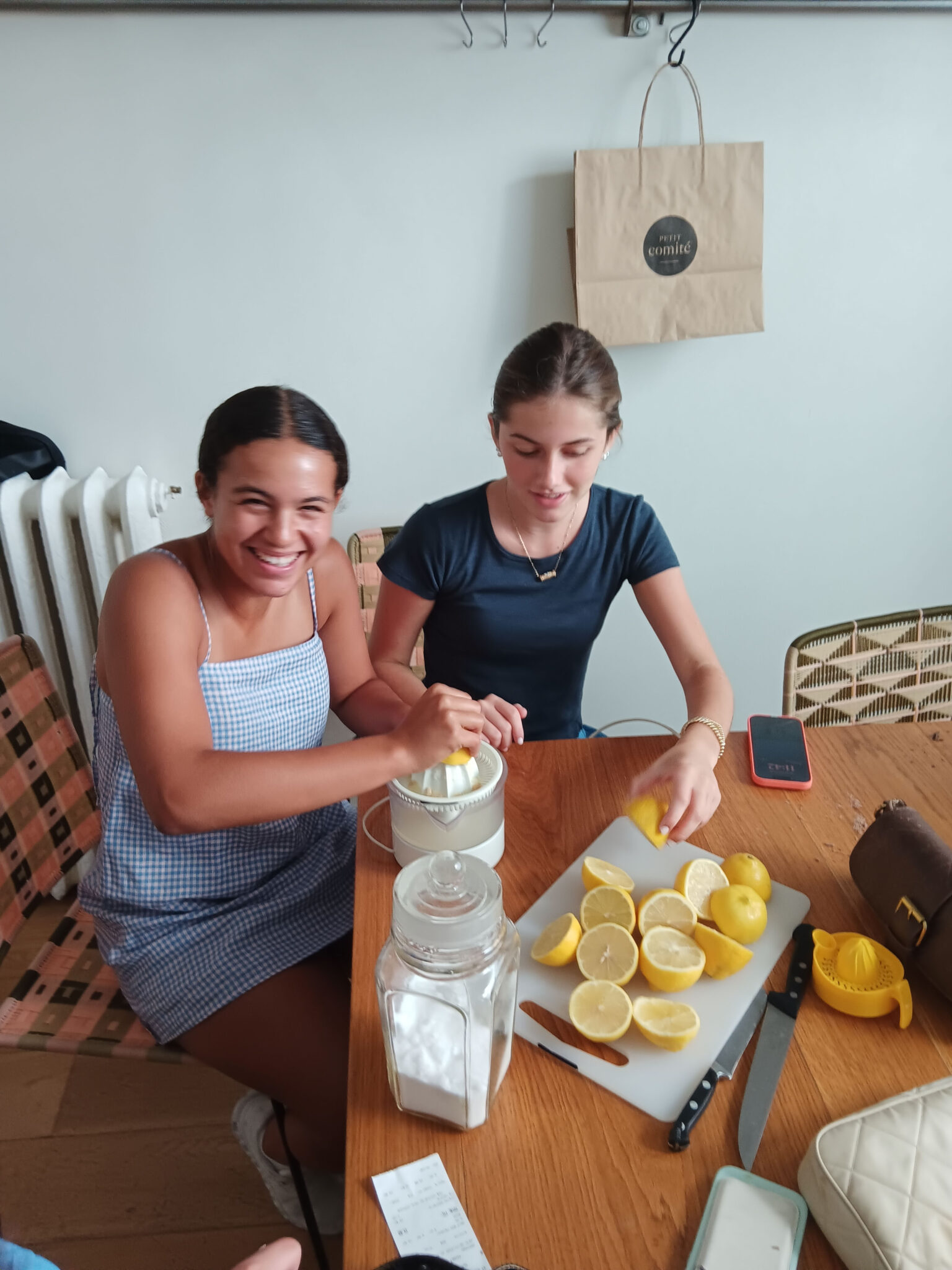 Two student squeeze lemon together laughing and smiling