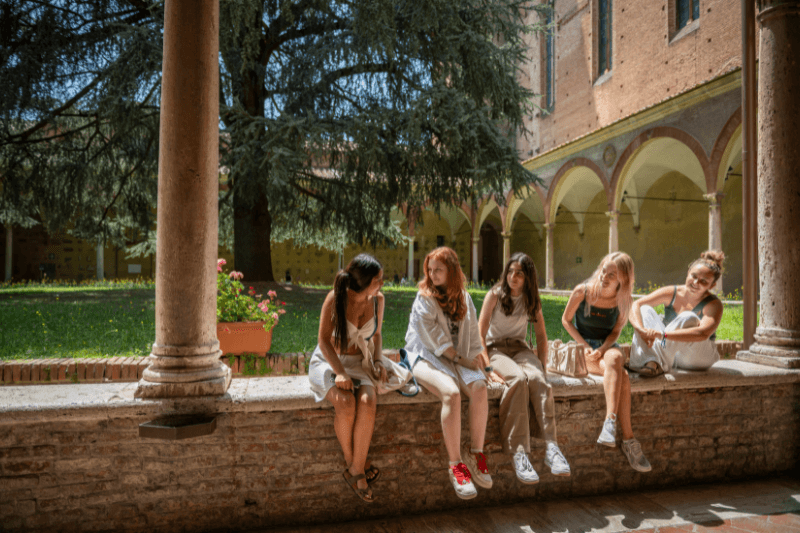 students sitting outside talking