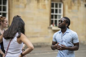 Faculty Pablo Wickham talks to students on the Oxford campus